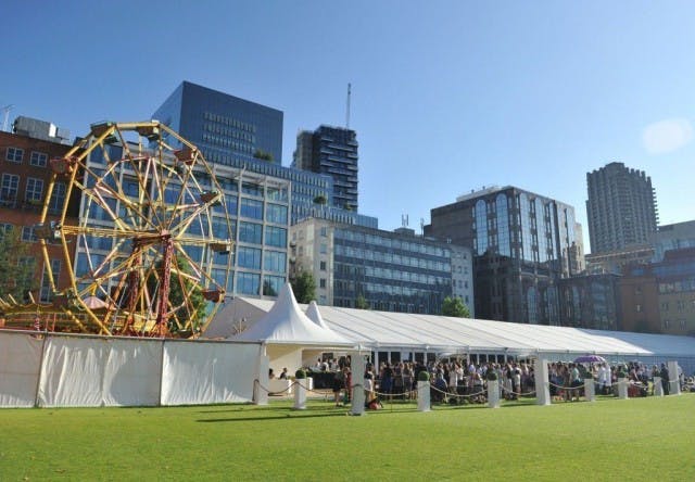 Funfair event at HAC with a large white tent and colorful Ferris wheel in City Central.