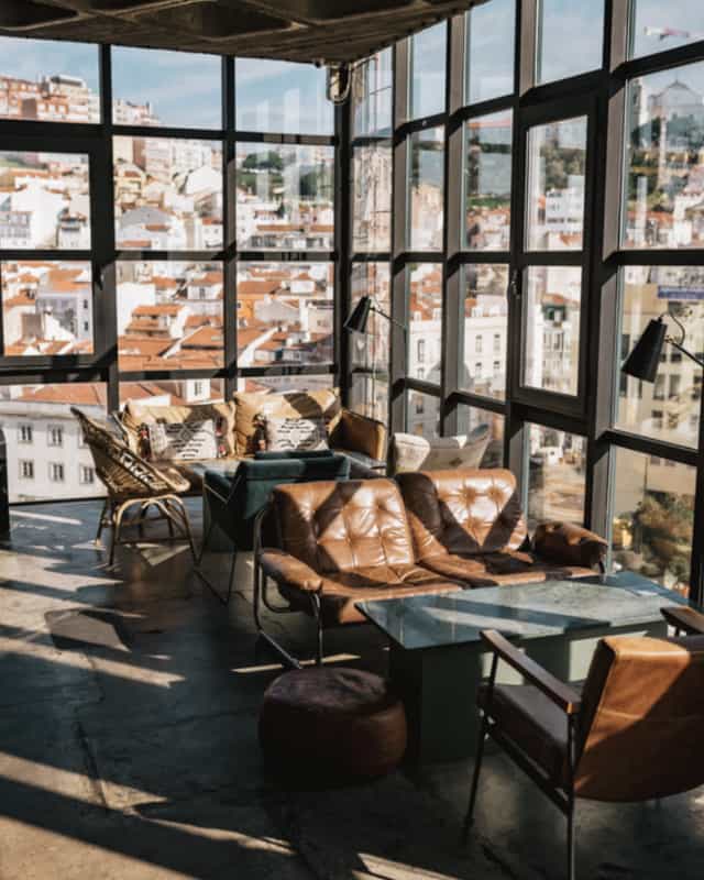 Stylish rooftop lounge in TOPO Lisboa with panoramic city views, ideal for networking events.