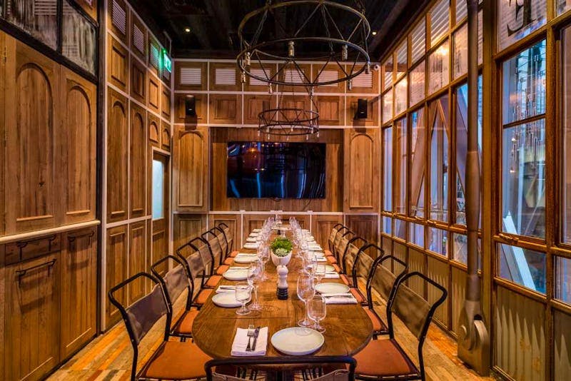 Private dining room with wooden decor for intimate meetings and exclusive events.