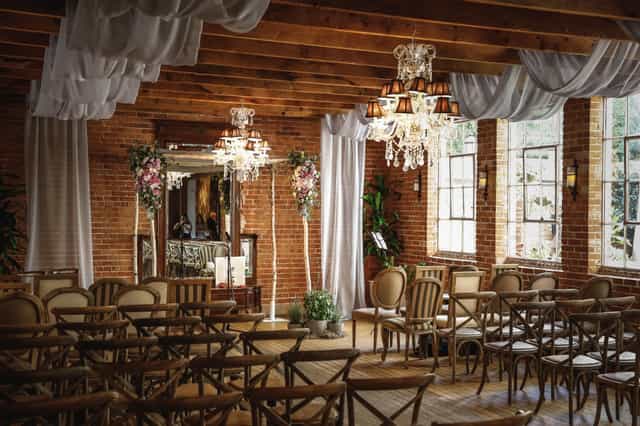 Carondelet House event space with rustic brick walls, ideal for weddings and gatherings.