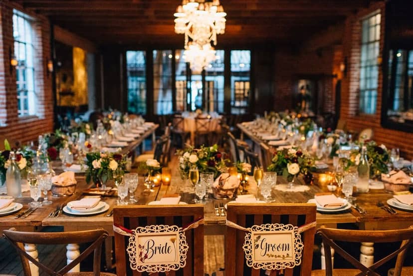 Carondelet House wedding reception with elegant tables and romantic chandelier lighting.