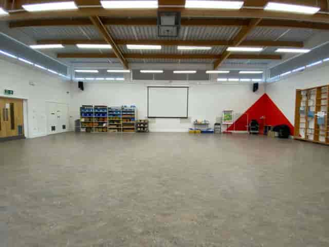 Versatile event space with large screen for meetings and workshops at Volume Unlimited.