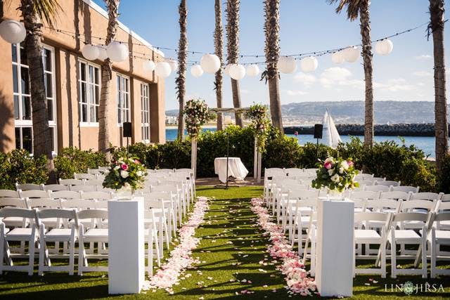 Outdoor wedding venue at The Portofino Hotel with floral arrangements and waterfront views.