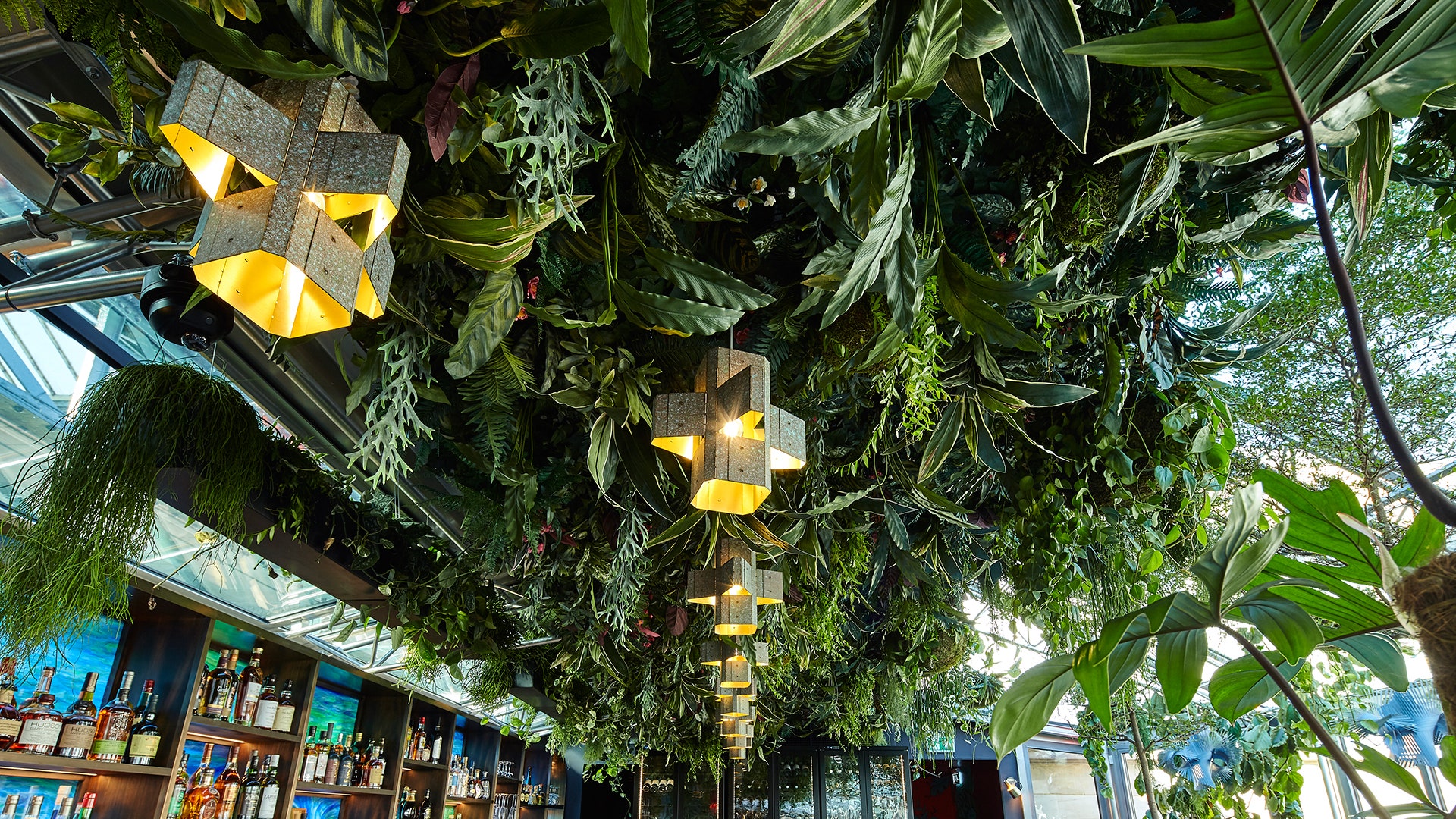 Vibrant SUSHISAMBA Covent Garden venue with lush green ceiling for elegant events.