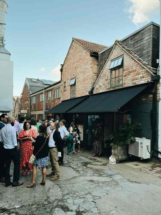 Private dining event at The Forge with rustic brick facade and vibrant outdoor networking.