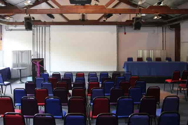 Versatile Watershed reception room with colorful chairs for meetings and presentations.