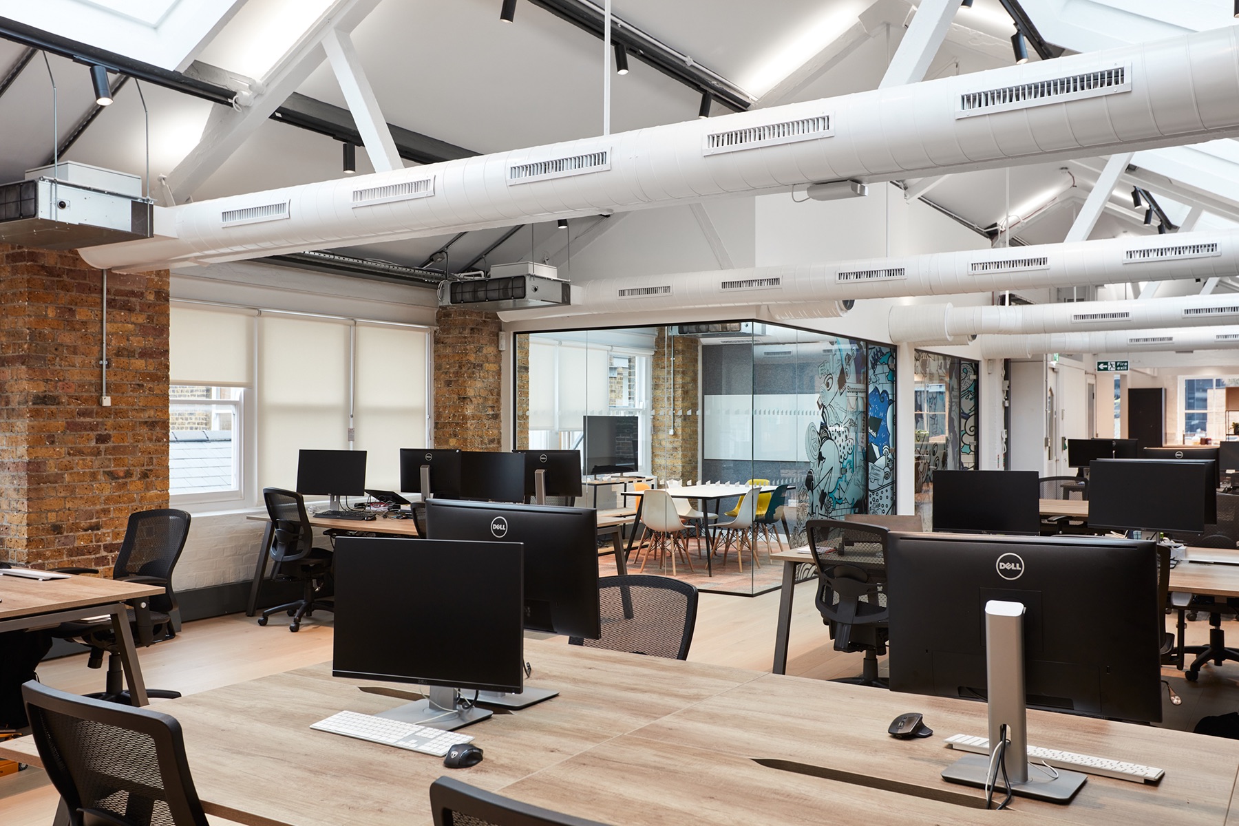 Modern open-plan office at Hutch Games Ltd. with natural light, ideal for workshops and meetings. - Banner