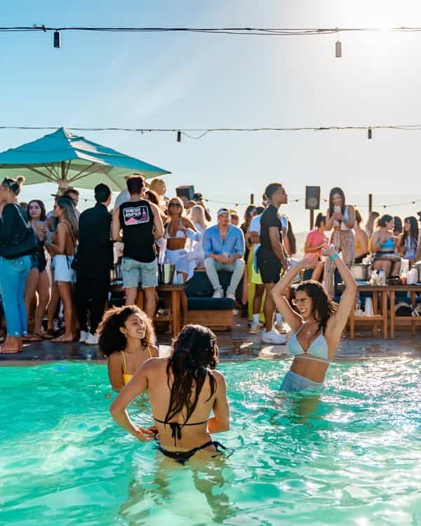 Vibrant poolside event at The Highlight Room with lounge seating and summer vibes.