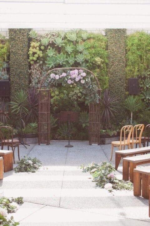 Garden Courtyard at SmogShoppe with floral arch, perfect for weddings and events.