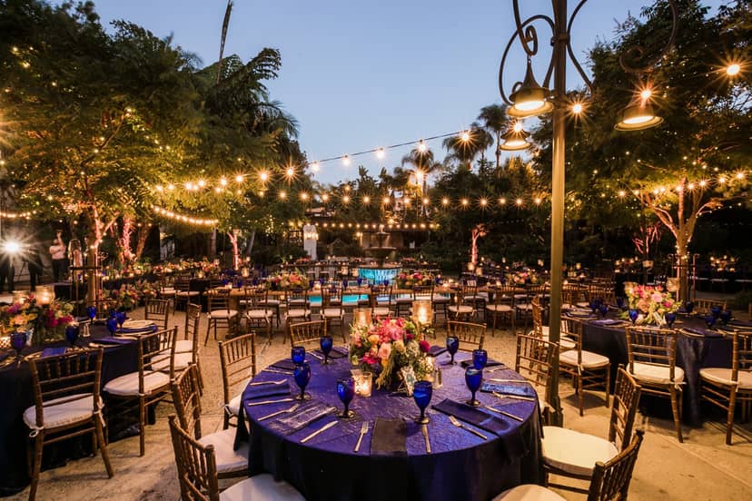 Elegant outdoor gala venue with floral centerpieces and string lights in Los Angeles.