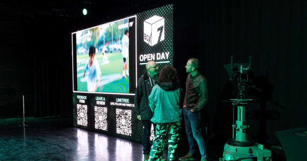 Podcast Room setup with digital screen for networking at open day event.