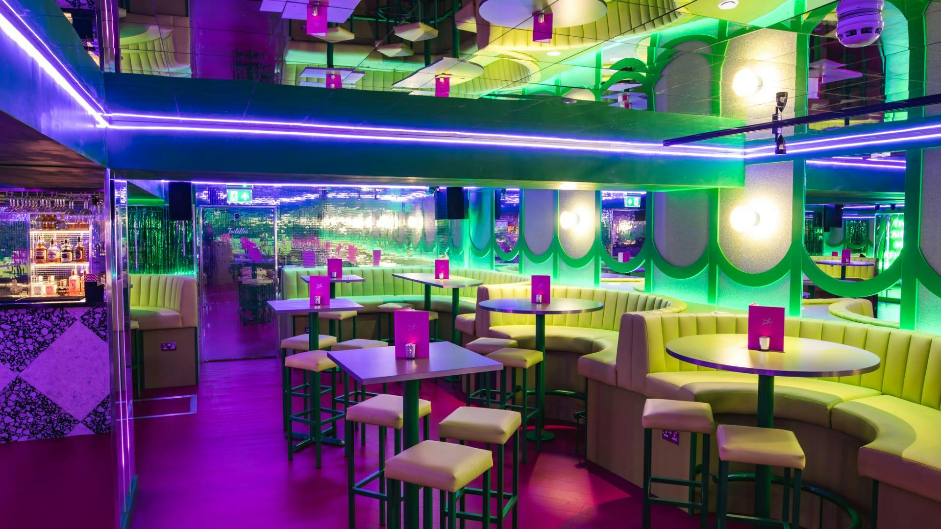 Vibrant Lounge in Box7 with neon lighting, ideal for social gatherings and events.