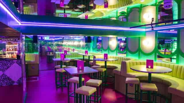 Vibrant Lounge in Box7 with neon lighting, ideal for social gatherings and events.