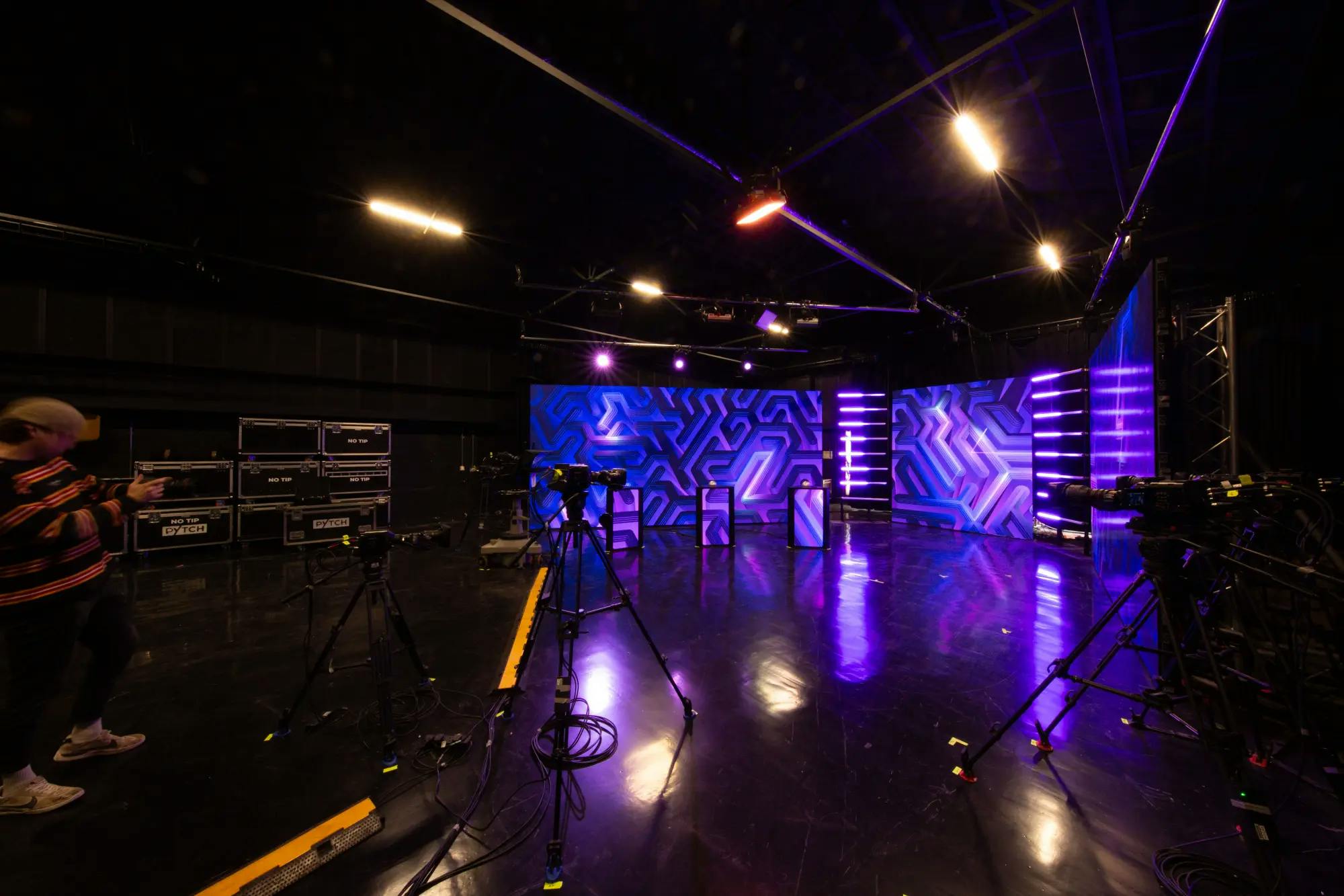 Modern event studio with vibrant lighting, ideal for live streaming and webinars.