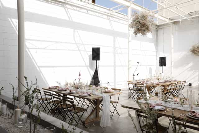 Elegant event venue in The Revery LA with wooden tables, ideal for gatherings and celebrations.