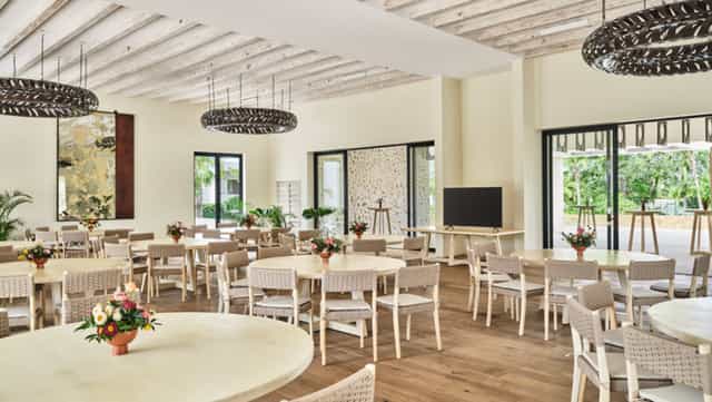 Modern event space with round tables, ideal for conferences and workshops.