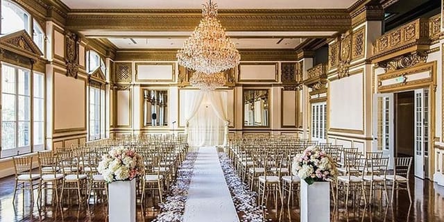 King Edward in Alexandria Ballrooms: elegant wedding venue with chandelier and floral decor.