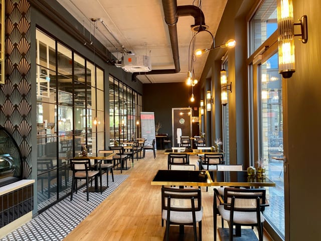 Stylish dining space with natural light for networking events and meetings.