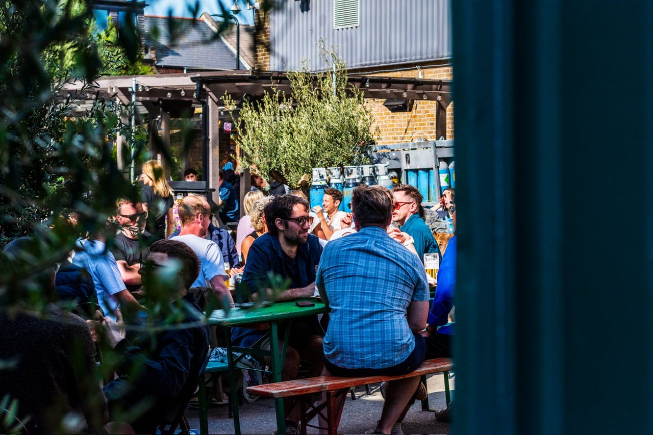 Vibrant outdoor courtyard at Five Points Taproom, perfect for networking events and mixers.