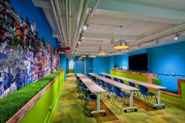 Vibrant OFFSITE meeting space with blue walls, ideal for workshops and collaboration.