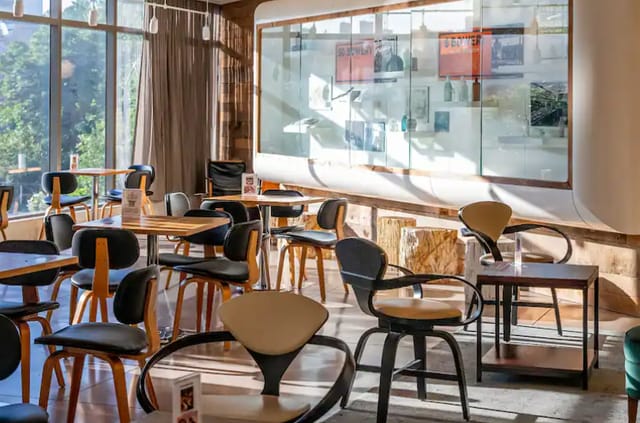 Modern meeting space at Hotel 50 Bowery with natural light, ideal for gatherings and networking.