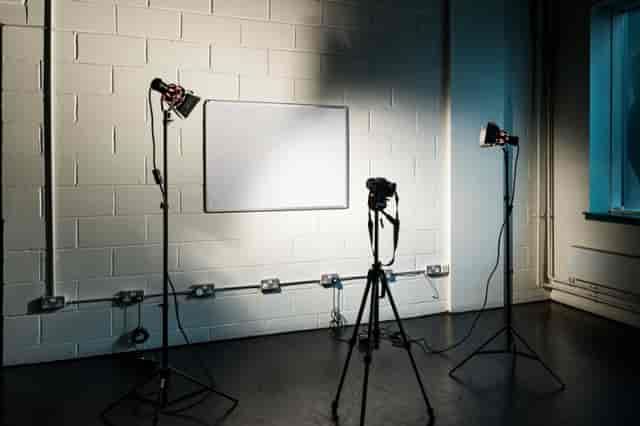 Minimalist meeting room with whiteboard, ideal for hybrid events and presentations.