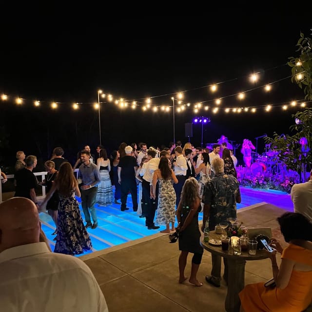 Queens Event Hall outdoor party with string lights and floral decor for celebrations.