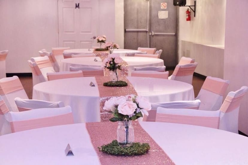 Elegant banquet hall with round tables, perfect for weddings and upscale events.