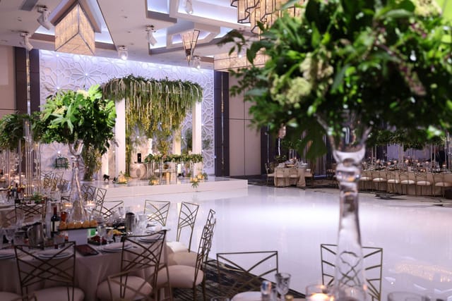 Elegant Quinceañera reception hall in L.A. with floral backdrop and upscale decor.