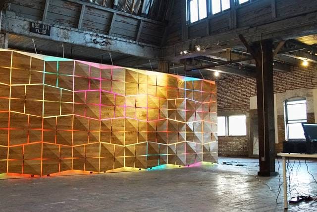 LED wall with neon colors in versatile event space for presentations and workshops.