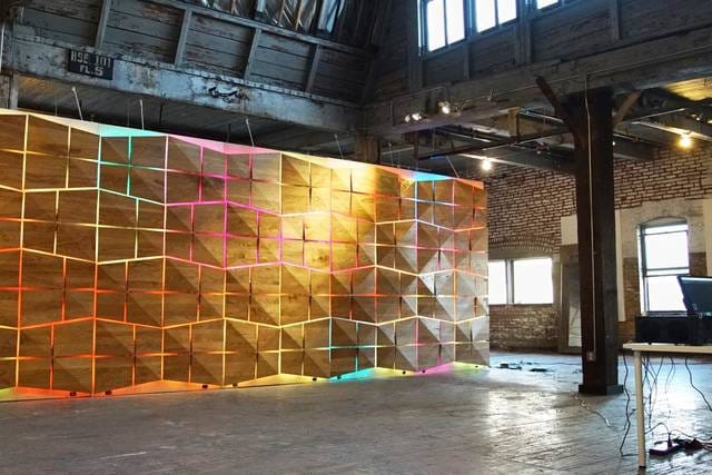 LED wall with neon colors in versatile event space for presentations and workshops.
