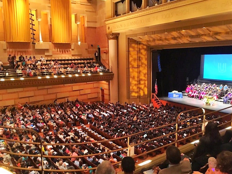 Royce Hall auditorium set for a formal graduation ceremony with elegant decor.