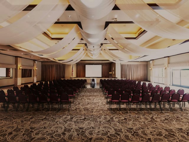 Indoor ballroom with elegant drapery, perfect for conferences and seminars.