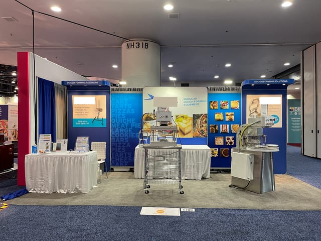 Trade show exhibit booth with branded graphics and engaging layout for events.