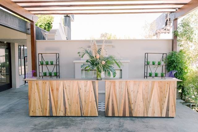 Stylish outdoor event space with wooden reception desk for sophisticated gatherings.