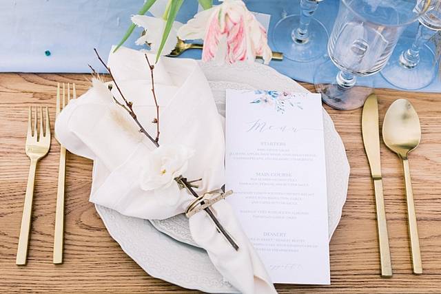 Elegant dining table setup with floral accents for upscale events and weddings.