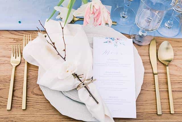 Elegant dining table setup with floral accents for upscale events and weddings.