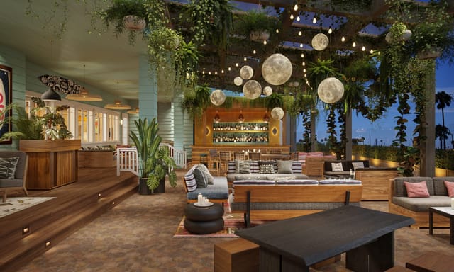 Elegant event space at The Bungalow Long Beach with lush greenery and cozy seating.