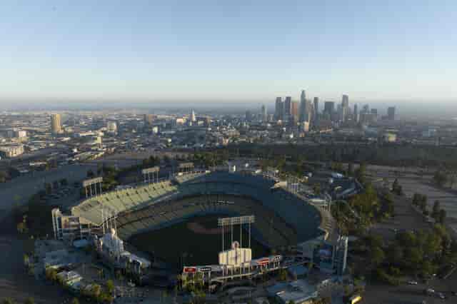 Aerial view of Dodger Stadium with Los Angeles skyline, perfect for corporate events.