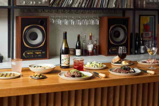 Elegant dining setup for corporate events with gourmet dishes and stylish speakers.