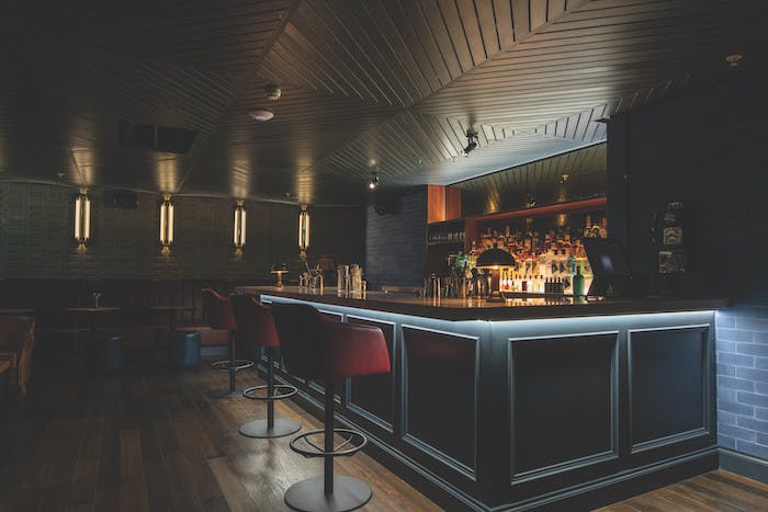 Sleek BrewDog Waterloo bar with warm lighting, ideal for networking events and gatherings.