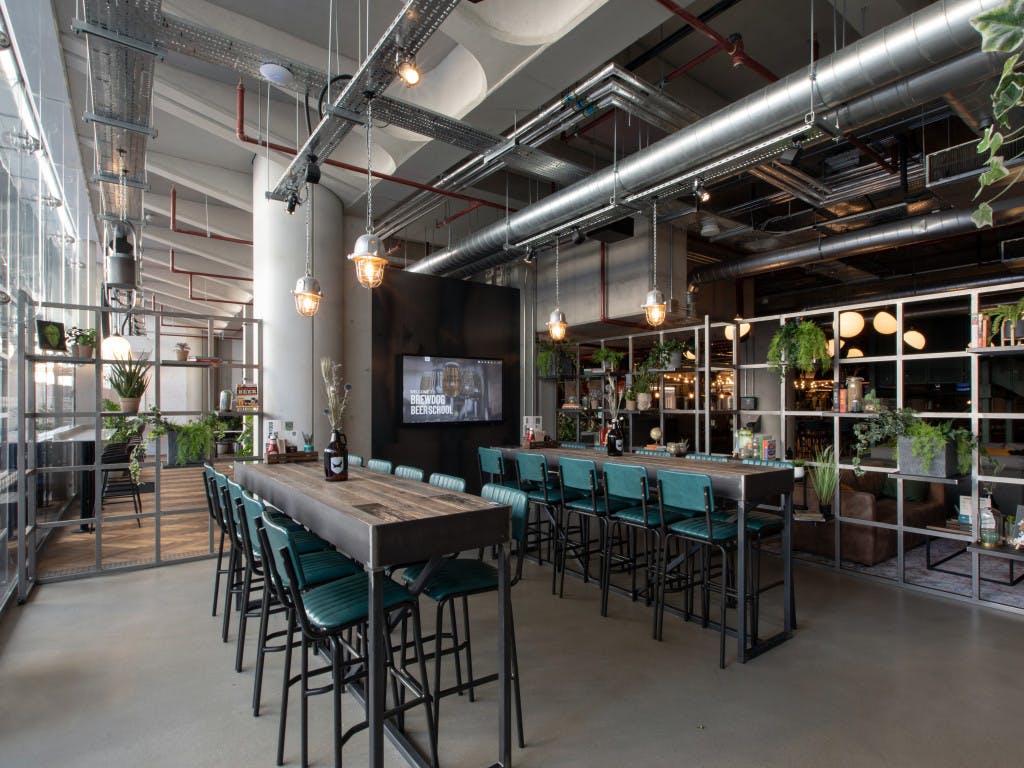 Modern event space at BrewDog Waterloo with communal table, ideal for networking and meetings.