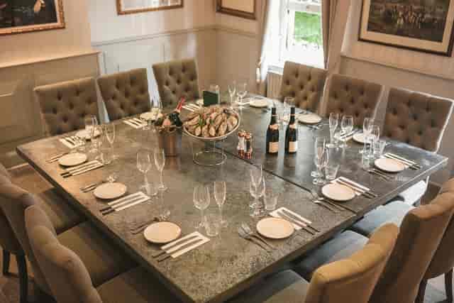 Elegant dining table with oysters and champagne for a corporate dinner event.