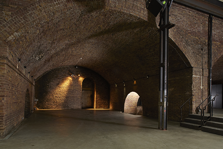 Spacious industrial venue with exposed brick, perfect for unique events and gatherings. - Banner