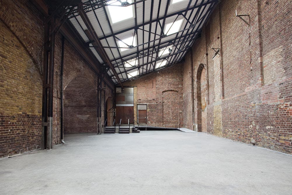 Industrial venue with exposed brick, perfect for creative events and conferences.