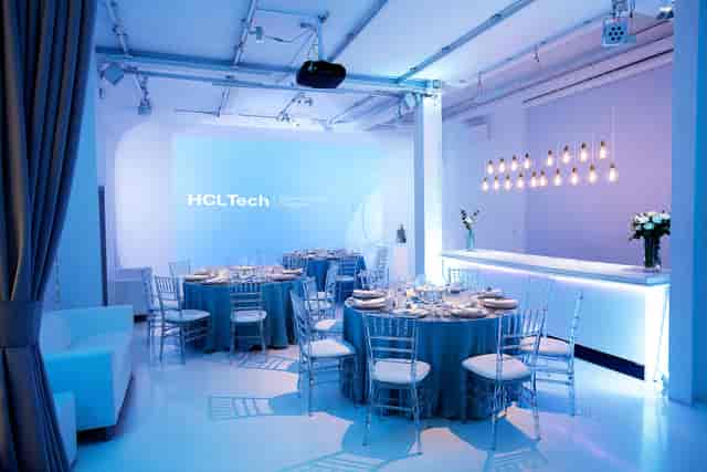 Modern corporate event space with blue linens, ideal for business meetings and networking.