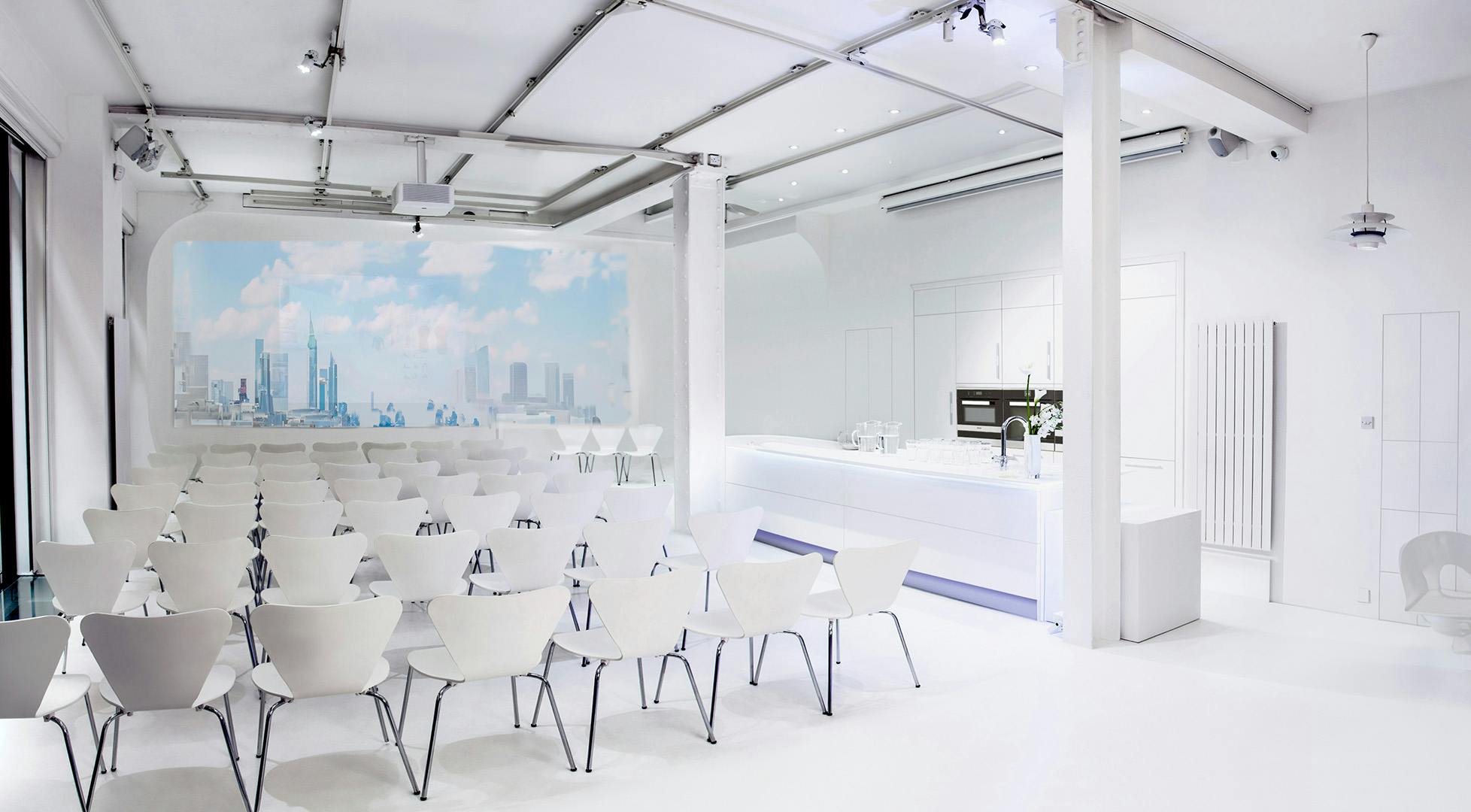 Modern corporate event space with city skyline, ideal for meetings and workshops.