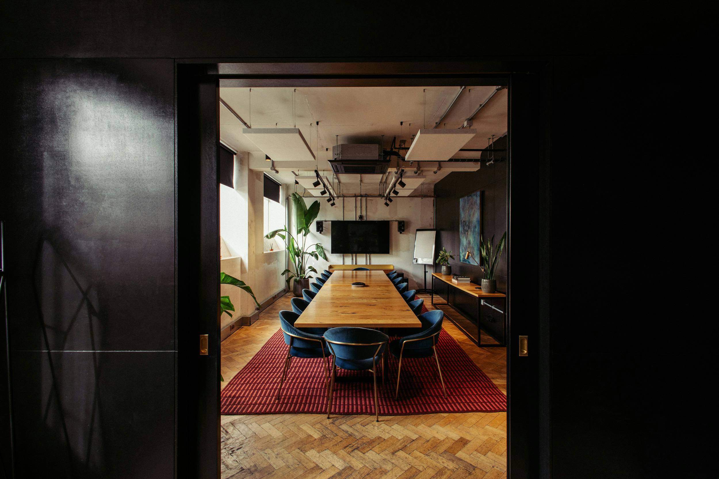 Modern conference room with wooden table and blue chairs for impactful meetings.