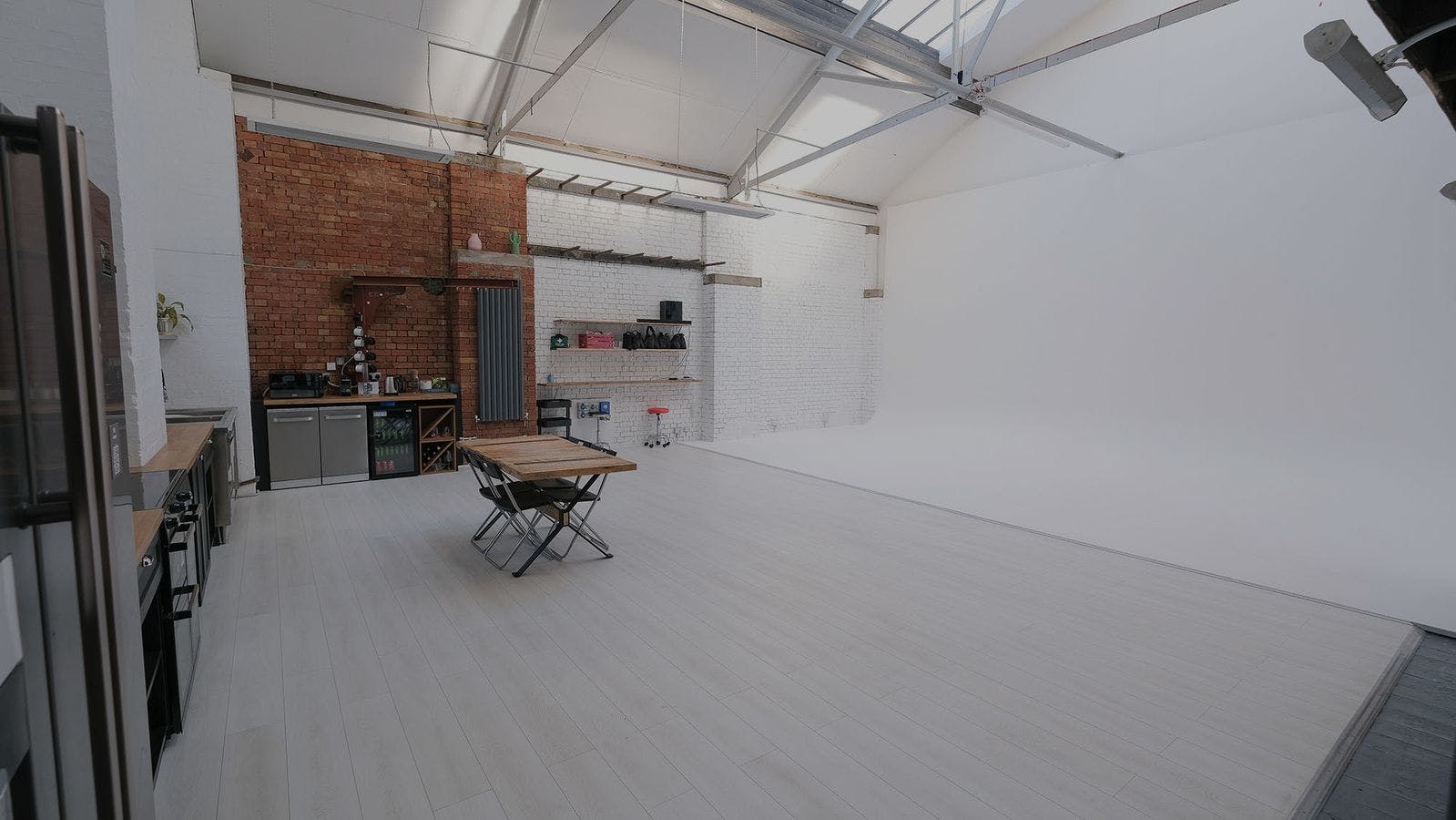 Infinity Cove event space with exposed brick, ideal for workshops and meetings.