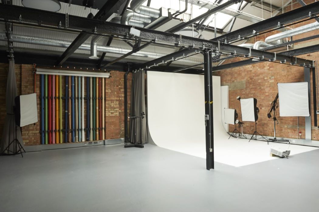 Infinity Cove event space with vibrant striped wall, ideal for creative meetings and photo shoots. - Banner